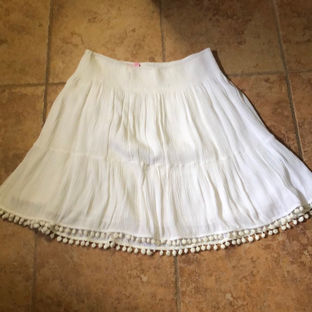Short flowy skirt with pom poms